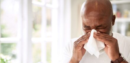 A man suffers from allergies in his home